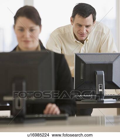 Businessman looking at computer View Large Photo Image Picture - Businessman looking at computer. Fotosearch