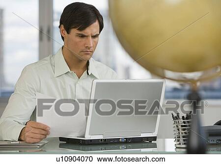 Businessman looking at laptop View Large Photo Image Stock Image - Businessman looking at laptop. Fotosearch