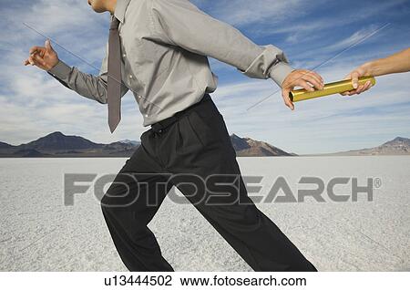 Businessman taking baton in relay race, Salt Flats, Utah, United States View Large Photo Image Stock Image - Businessman taking baton in relay race, Salt Flats, Utah, United States. Fotosearch