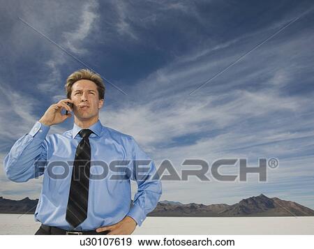 Businessman talking on cell phone, Salt Flats, Utah, United States View Large Photo Image Stock Photo - Businessman talking on cell phone, Salt Flats, Utah, United States. Fotosearch