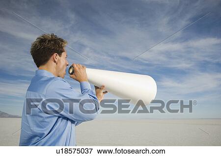 Businessman yelling into megaphone, Salt Flats, Utah, United States View Large Photo Image Stock Photo - Businessman yelling into megaphone, Salt Flats, Utah, United States. Fotosearch