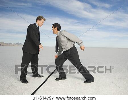 Businessmen on opposite sides of line, Salt Flats, Utah, United States View Large Photo Image Stock Photo - Businessmen on opposite sides of line, Salt Flats, Utah, United States. Fotosearch