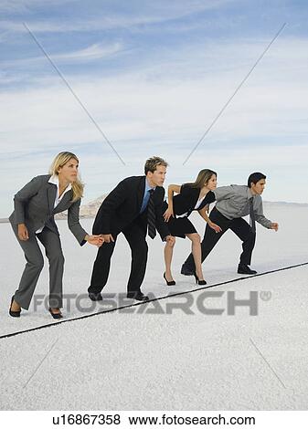 Stock Photo - Businesspeople at starting line for race, Salt Flats, Utah, United States. Fotosearch