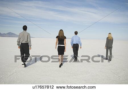 Stock Image - Businesspeople walking on salt flats, Salt Flats, Utah, United States. Fotosearch