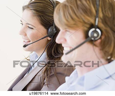 Picture - Businesspeople wearing headsets. Fotosearch