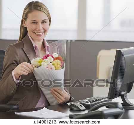 Businesswoman holding bouquet of flowers View Large Photo Image Stock Image - Businesswoman holding bouquet of flowers. Fotosearch