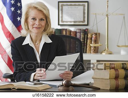 Businesswoman holding paperwork View Large Photo Image Stock Image - Businesswoman holding paperwork. Fotosearch