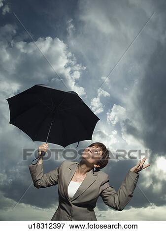 Businesswoman holding umbrella View Large Photo Image Stock Photo - Businesswoman holding umbrella. Fotosearch