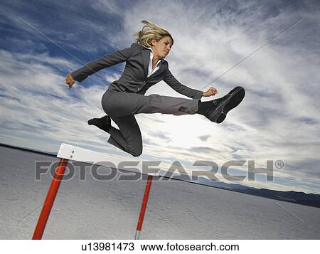 Businesswoman jumping over hurdle, Salt Flats, Utah, United States View Large Photo Image Stock Image - Businesswoman jumping over hurdle, Salt Flats, Utah, United States. Fotosearch