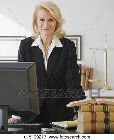 Businesswoman leaning on desk View Large Photo Image Stock Photo - Businesswoman leaning on desk. Fotosearch