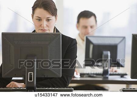 Stock Photo - Businesswoman looking at computer. Fotosearch