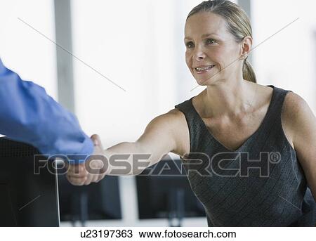 Businesswoman shaking coworker’s hand View Large Photo Image Stock Image - Businesswoman shaking coworker’s hand. Fotosearch