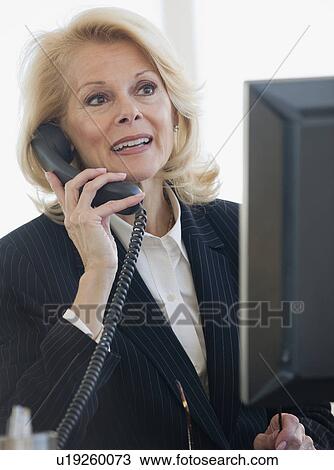 Businesswoman talking on telephone View Large Photo Image Stock Image - Businesswoman talking on telephone. Fotosearch
