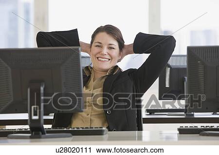 Businesswoman with hands behind head View Large Photo Image Stock Image - Businesswoman with hands behind head. Fotosearch