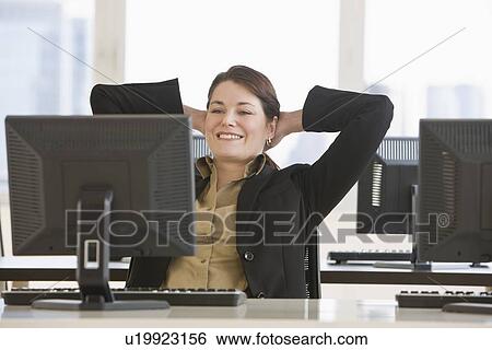 Stock Photograph - Businesswoman with hands behind head. Fotosearch