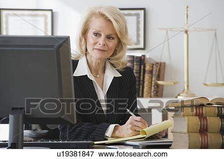 Businesswoman writing on notepad View Large Photo Image Stock Photo - Businesswoman writing on notepad. Fotosearch