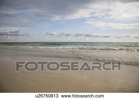 Stock Image - Calm ocean surf under blue sky, Florida, United States. Fotosearch