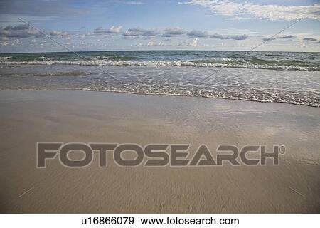 Stock Photo - Calm ocean surf under blue sky, Florida, United States. Fotosearch