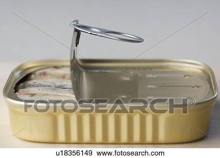 Stock Photo - Can of sardines partly opened. Fotosearch