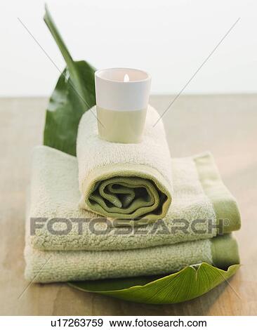 Candle on rolled towels View Large Photo Image Stock Photo - Candle on rolled towels. Fotosearch