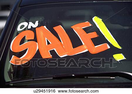 Stock Photograph - Car with On Sale on windshield. Fotosearch