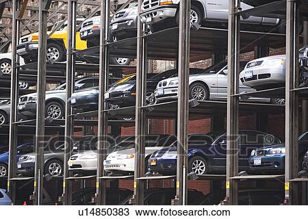Cars stacked in urban parking lot View Large Photo Image Stock Image - Cars stacked in urban parking lot. Fotosearch