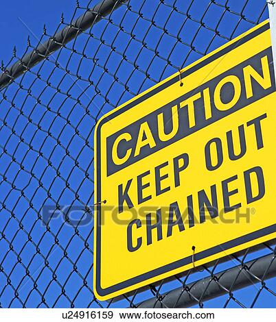 Stock Photo - Caution Keep Out sign on fence. Fotosearch