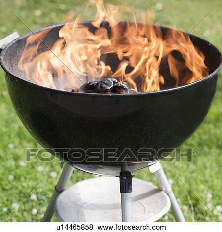 Stock Photo - Charcoal burning in a grill. Fotosearch