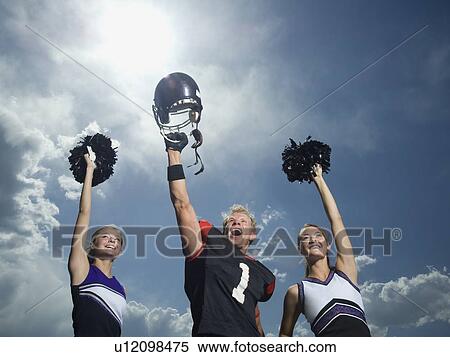 Cheerleaders and football player cheering View Large Photo Image Stock Photography - Cheerleaders and football player cheering. Fotosearch