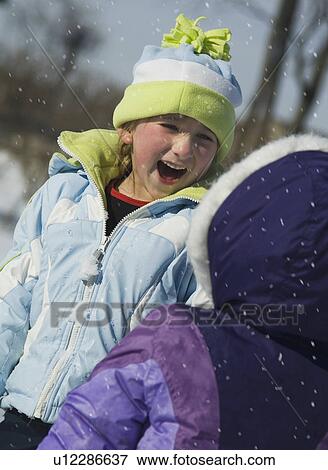 Stock Photo - Children laughing in snow. Fotosearch