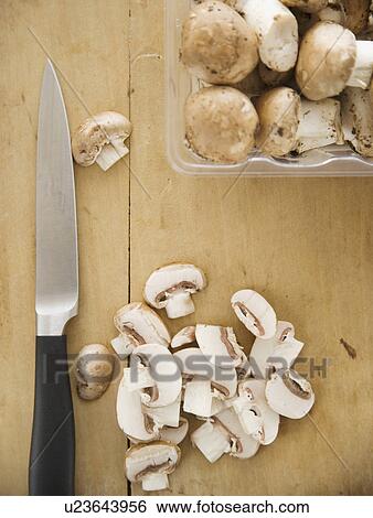 Chopped mushrooms on cutting board View Large Photo Image Stock Photograph - Chopped mushrooms on cutting board. Fotosearch