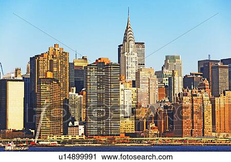 Stock Image - City skyline along water. Fotosearch