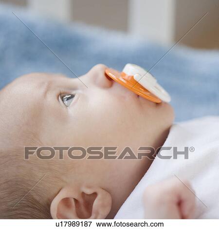 Close up of baby with pacifier View Large Photo Image Stock Photo - Close up of baby with pacifier. Fotosearch