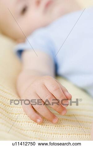 Stock Image - Close up of baby’s hand. Fotosearch