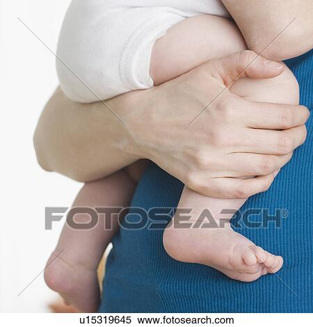 Close up of baby’s legs being held by mother View Large Photo Image Stock Photography - Close up of baby’s legs being held by mother. Fotosearch