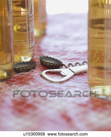 Close up of beer bottles and bottle opener View Large Photo Image Stock Photo - Close up of beer bottles and bottle opener. Fotosearch