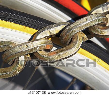 Close up of chain over bicycle tire View Large Photo Image Stock Photo - Close up of chain over bicycle tire. Fotosearch