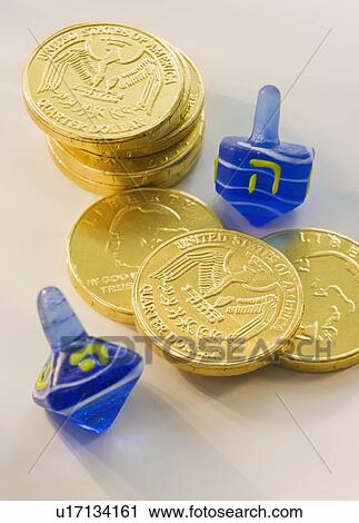 Stock Image - Close up of Chanukah coins and dreidels. Fotosearch
