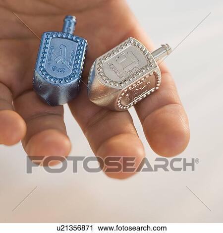 Close up of dreidel in man’s hand View Large Photo Image Stock Image - Close up of dreidel in man’s hand. Fotosearch