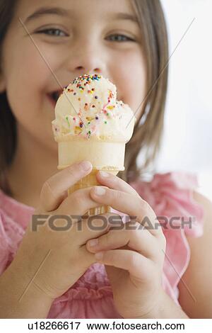 Close up of girl eating ice cream cone View Large Photo Image Stock Photo - Close up of girl eating ice cream cone. Fotosearch