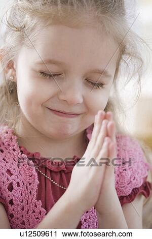 Close up of girl praying View Large Photo Image Stock Image - Close up of girl praying. Fotosearch