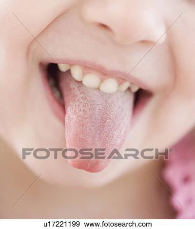 Close up of girl sticking out tongue View Large Photo Image Stock Photo - Close up of girl sticking out tongue. Fotosearch