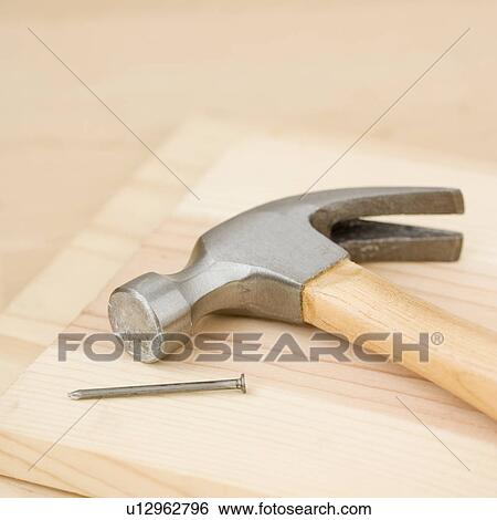 Stock Photograph - Close up of hammer and nail. Fotosearch
