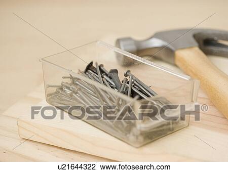 Stock Image - Close up of hammer and nails. Fotosearch