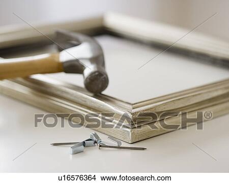 Close up of hammer, nails and picture frame View Large Photo Image Picture - Close up of hammer, nails and picture frame. Fotosearch