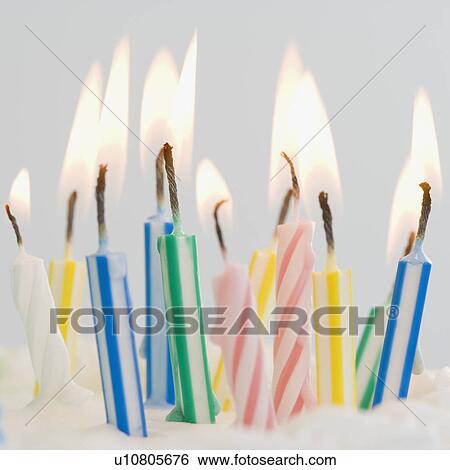 Stock Photograph - Close up of lit birthday candles. Fotosearch