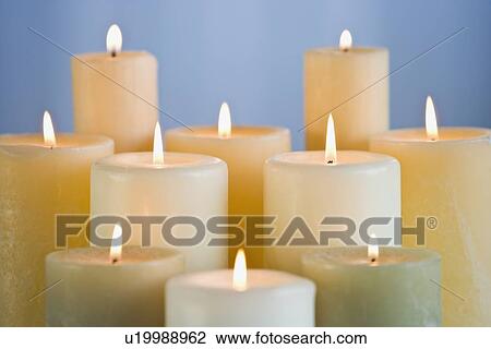 Stock Image - Close up of lit candles. Fotosearch
