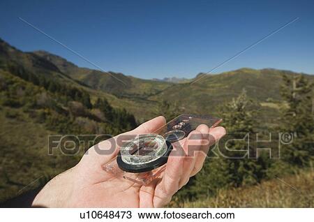 Close up of man holding compass, Utah, United States View Large Photo Image Stock Image - Close up of man holding compass, Utah, United States. Fotosearch