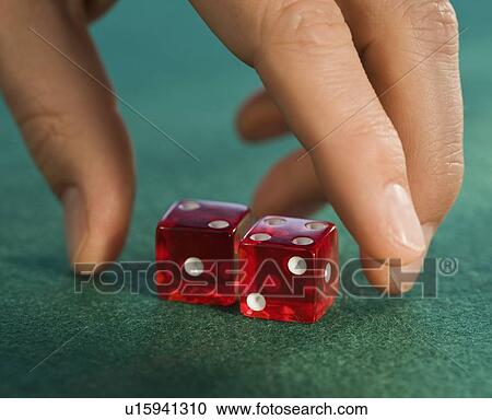 Close up of man reaching for dice View Large Photo Image Stock Image - Close up of man reaching for dice. Fotosearch