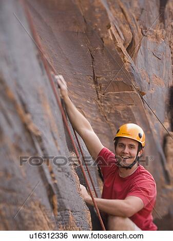 Close up of man rock climbing View Large Photo Image Stock Photograph - Close up of man rock climbing. Fotosearch